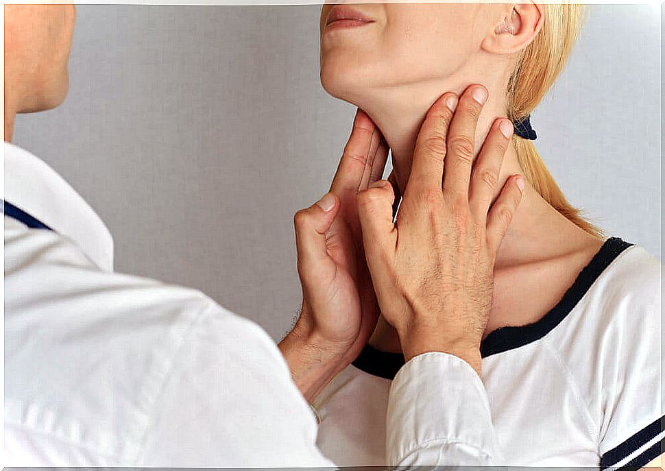 Doctor examining a woman's thyroid.