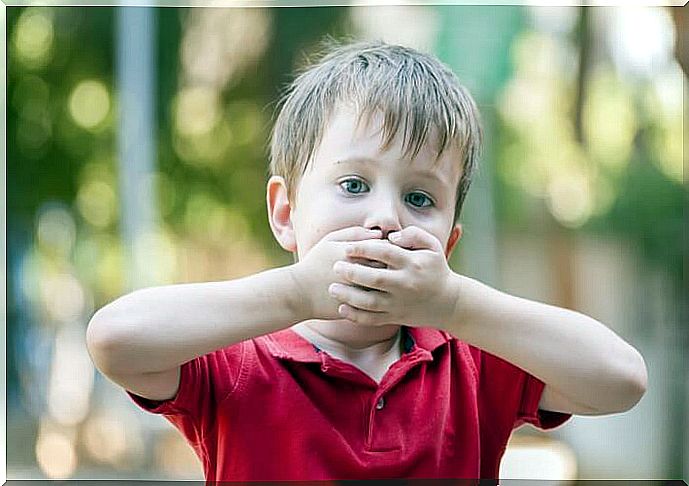 Child with hands in mouth.